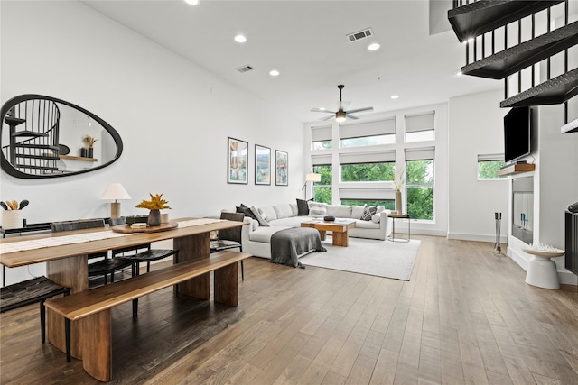 living room featuring wood-type flooring and ceiling fan