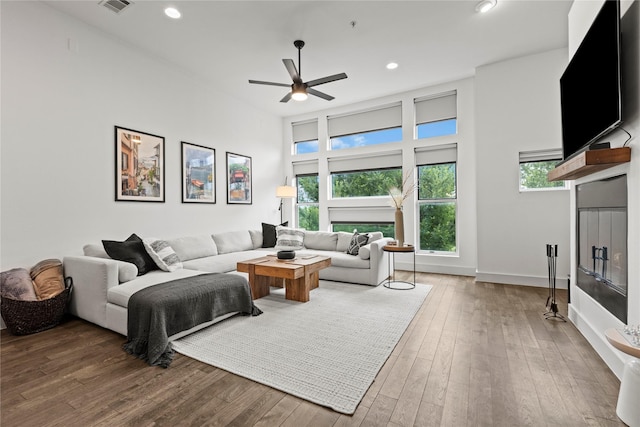 living room with ceiling fan and wood-type flooring