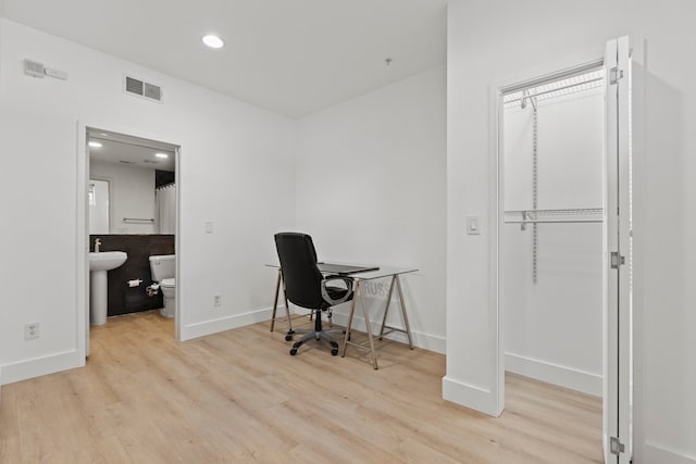 office space with light hardwood / wood-style flooring