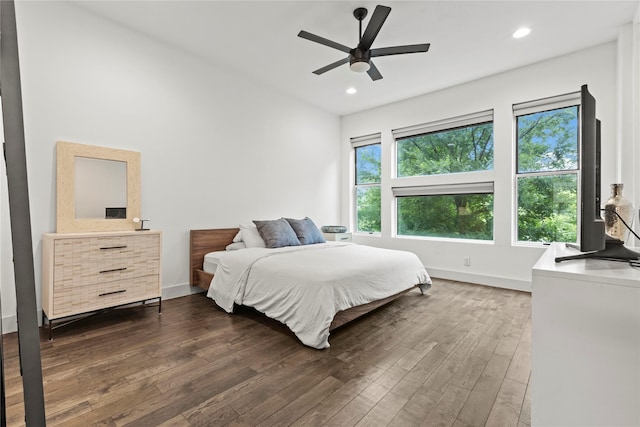 bedroom with ceiling fan and dark hardwood / wood-style flooring