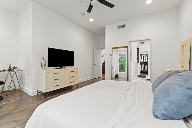 bedroom featuring ceiling fan, dark wood-type flooring, and a high ceiling