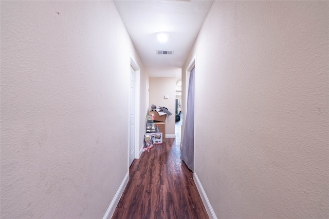 corridor with dark wood-type flooring