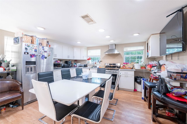 dining space with light hardwood / wood-style floors