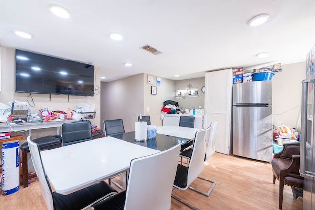 dining area with light hardwood / wood-style flooring