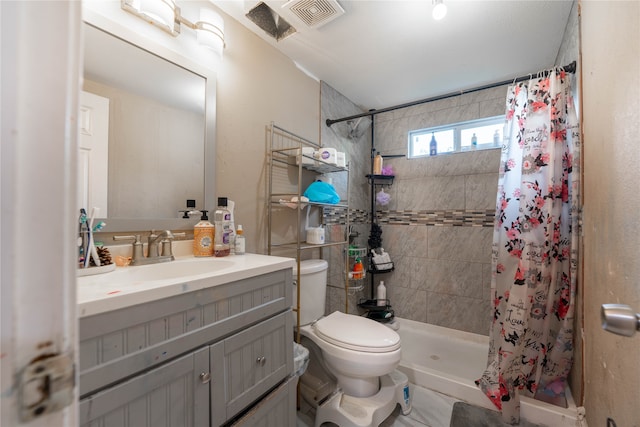 bathroom with vanity, tile patterned floors, walk in shower, and toilet