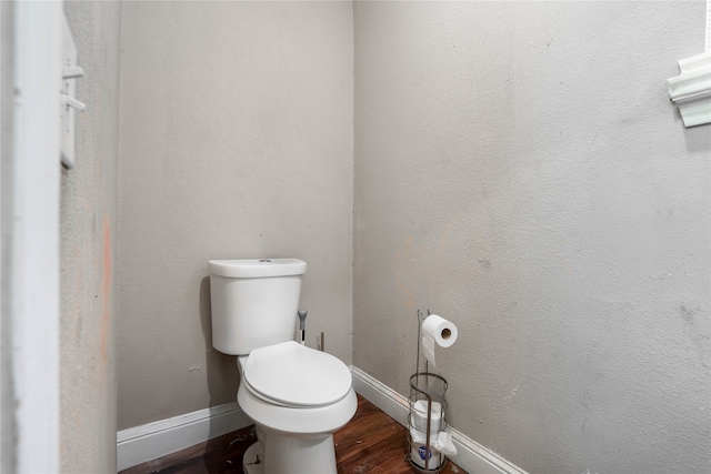 bathroom with hardwood / wood-style flooring and toilet