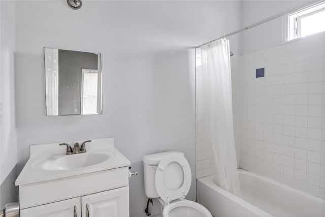 full bathroom with a healthy amount of sunlight, shower / bath combination with curtain, vanity, and toilet