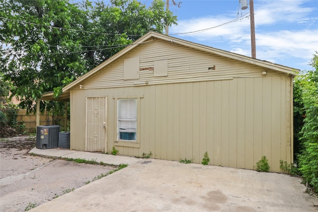 exterior space with central AC unit and a patio