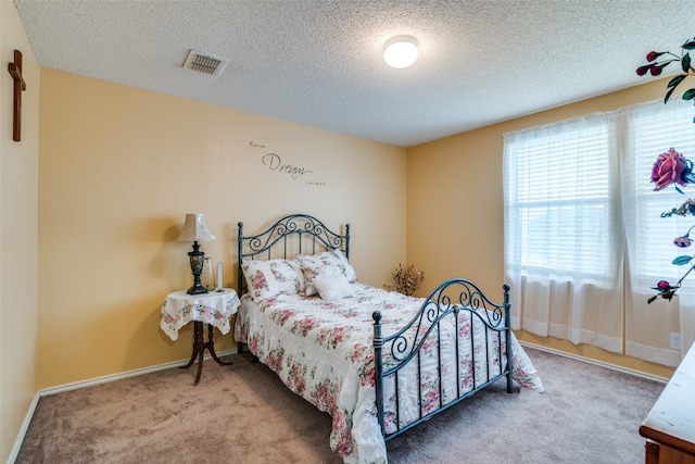 carpeted bedroom featuring a textured ceiling