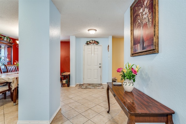 tiled entrance foyer featuring a textured ceiling