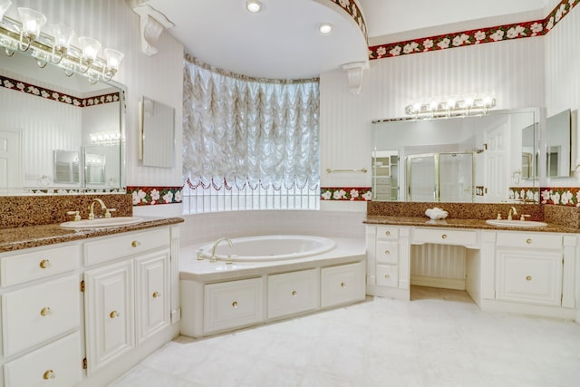 bathroom with vanity and independent shower and bath