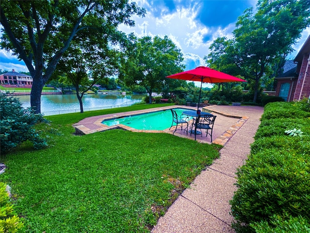 view of pool with a water view, a patio area, and a lawn