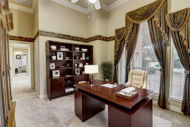 carpeted office space with ceiling fan, a towering ceiling, and ornamental molding