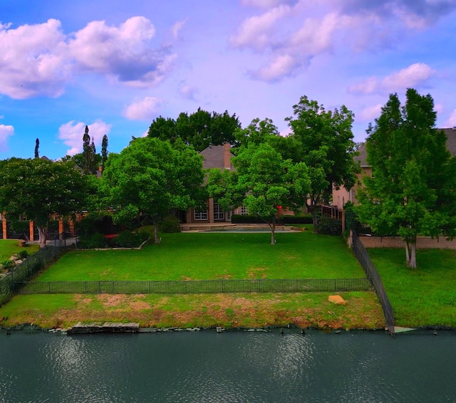 exterior space featuring a yard and a water view