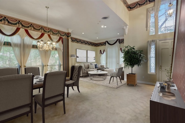 dining area featuring carpet flooring, a wealth of natural light, an inviting chandelier, and ornamental molding