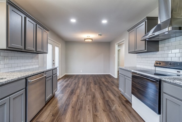 kitchen with white electric range, dark hardwood / wood-style flooring, wall chimney range hood, light stone counters, and dishwasher