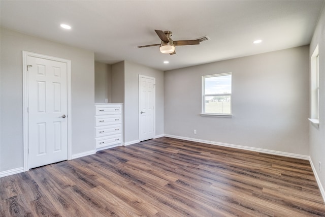 unfurnished bedroom featuring ceiling fan and dark wood-type flooring