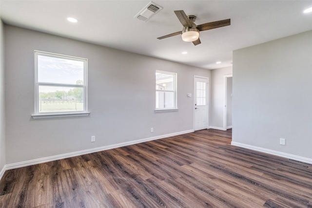 spare room with dark hardwood / wood-style flooring and ceiling fan