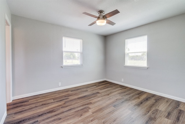 spare room featuring ceiling fan and dark wood-type flooring