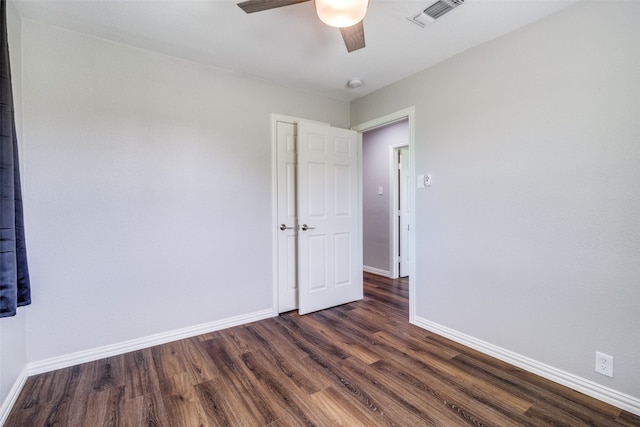 unfurnished room featuring dark hardwood / wood-style floors and ceiling fan