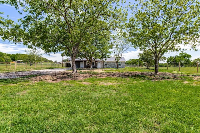 view of yard with a rural view