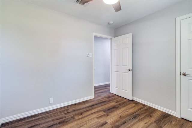 unfurnished room featuring dark hardwood / wood-style flooring and ceiling fan