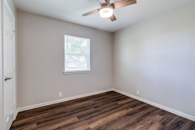 spare room with dark hardwood / wood-style flooring and ceiling fan