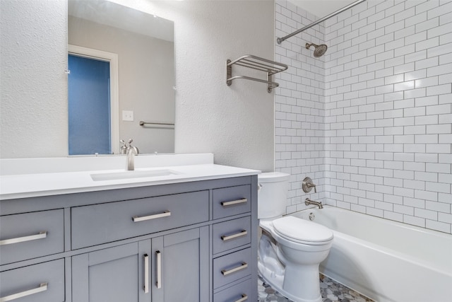 full bathroom featuring tiled shower / bath combo, vanity, tile floors, and toilet