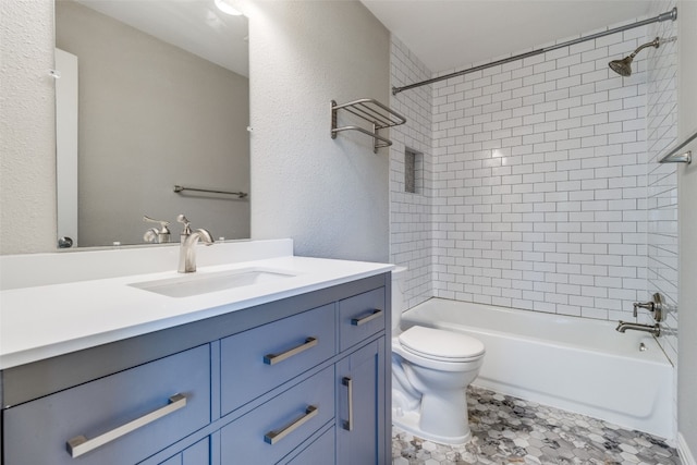 full bathroom featuring tiled shower / bath combo, toilet, tile flooring, and vanity