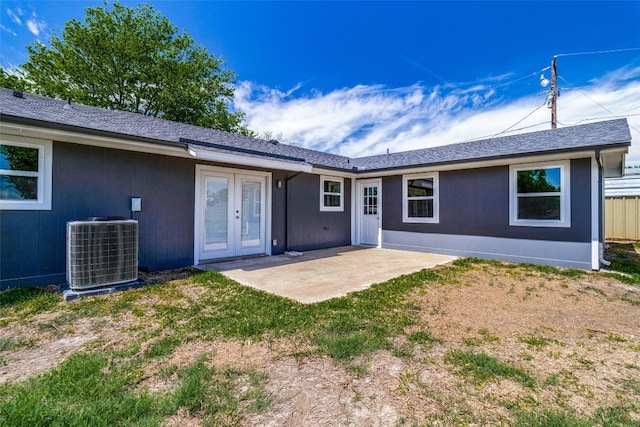 back of property with french doors, central air condition unit, and a patio