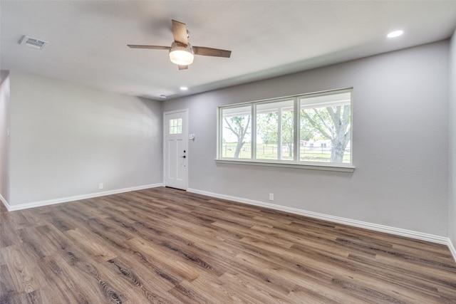 empty room featuring ceiling fan and dark hardwood / wood-style floors