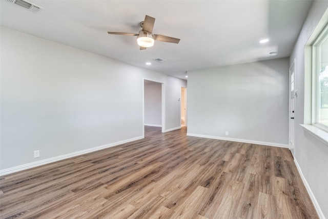 empty room featuring wood-type flooring and ceiling fan