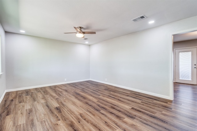 unfurnished room with ceiling fan and dark hardwood / wood-style floors