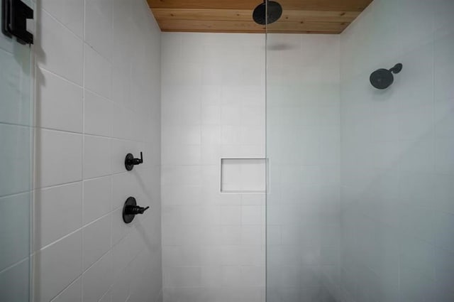 interior details featuring wooden ceiling and tiled shower