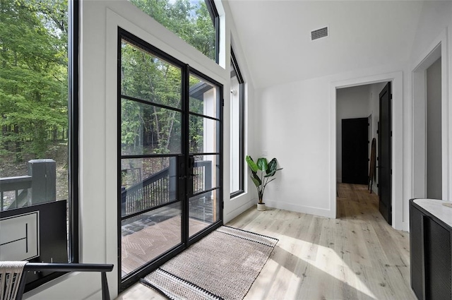 doorway with light wood-type flooring