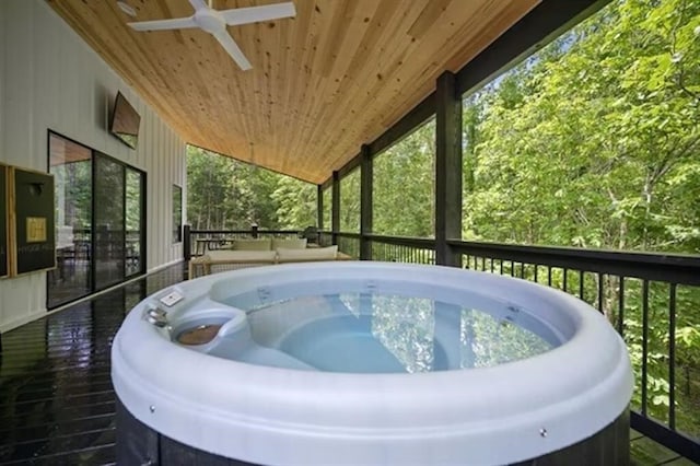 sunroom with wood ceiling, ceiling fan, vaulted ceiling, and a hot tub