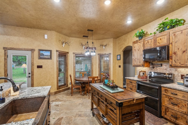 kitchen featuring hanging light fixtures, tasteful backsplash, stainless steel range with electric stovetop, a chandelier, and light stone countertops