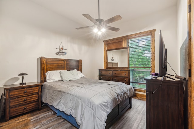 bedroom with ceiling fan and dark hardwood / wood-style floors