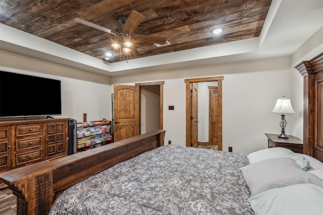 bedroom with ceiling fan, a raised ceiling, and wooden ceiling