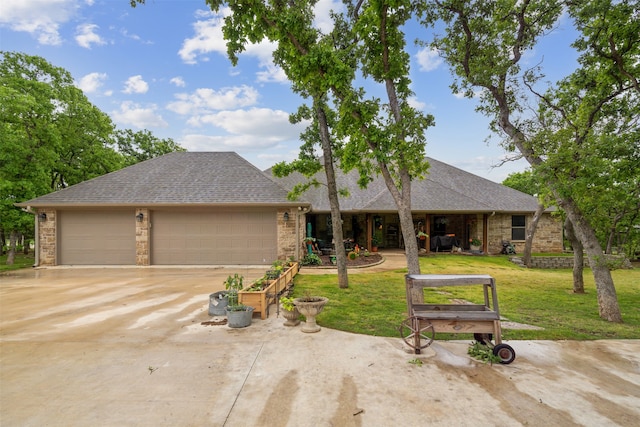 ranch-style home with a garage and a front lawn