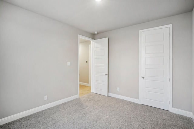 unfurnished bedroom with light carpet