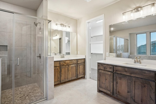 bathroom featuring tile patterned flooring, vanity, and an enclosed shower