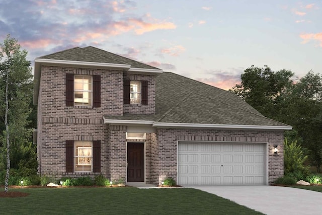 view of front facade with a garage and a lawn