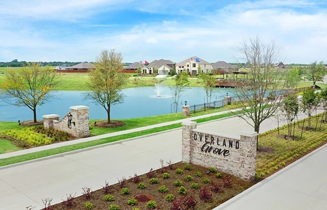 community / neighborhood sign featuring a water view