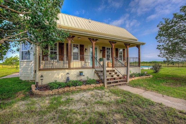 view of front of property with a front yard and covered porch