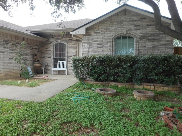 view of exterior entry with a patio