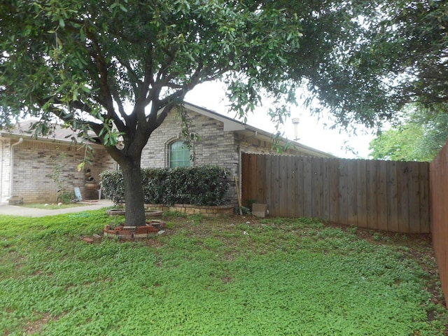 view of side of home featuring a lawn