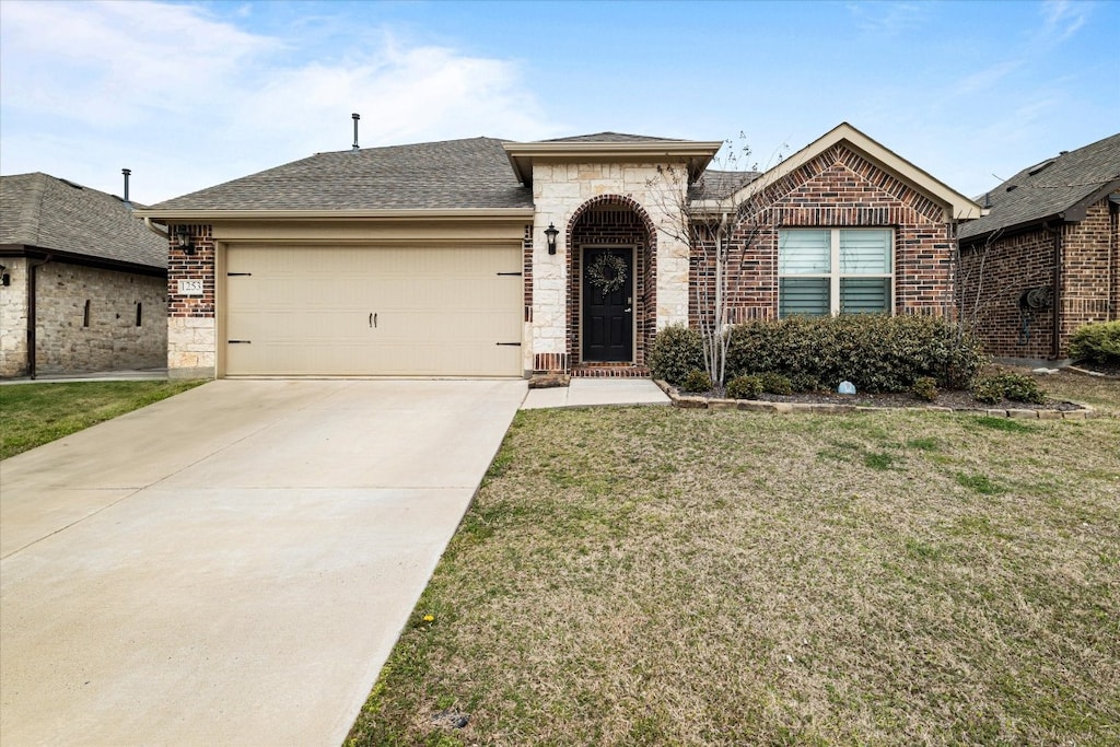 ranch-style house featuring a garage and a front yard