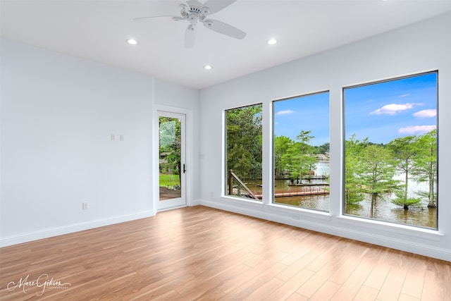 empty room with light hardwood / wood-style flooring and ceiling fan