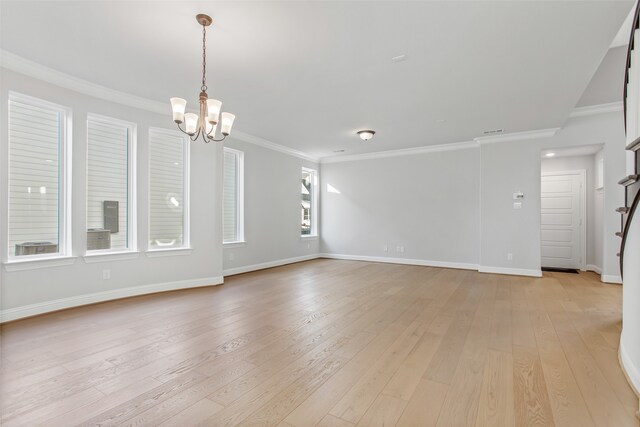 interior space featuring light hardwood / wood-style flooring, a notable chandelier, and crown molding